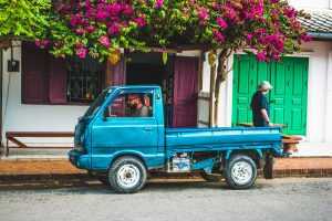 Small blue truck parked in a street