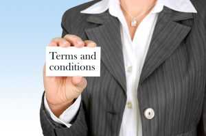 A woman holding a small card with the words "Terms and conditions" on it