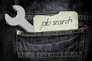 Denim pants with a wrench and a piece of paper with the words "job search"